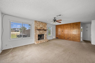 Unfurnished living room with carpet, a fireplace,