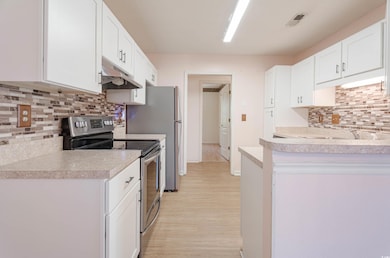 Kitchen featuring light wood finished floors, ligh