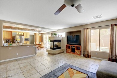 TWO WAY FIREPLACE SEPARATES THE FAMILY ROOM AND KI