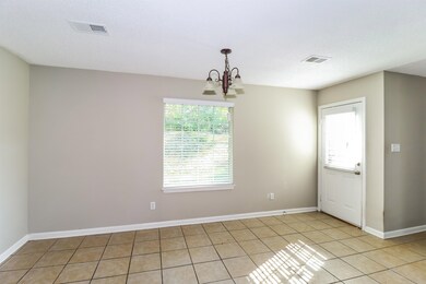 Empty room featuring a chandelier and light tile patterned floors