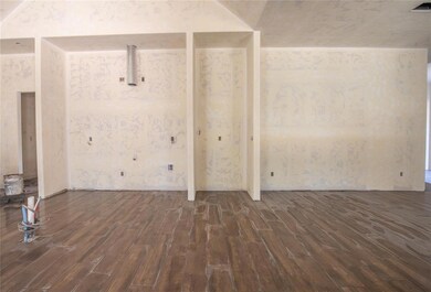 Spare room featuring dark wood-type flooring