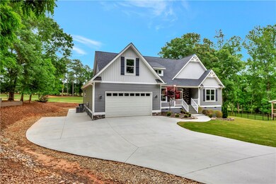 Front of home with extra parking on the side
