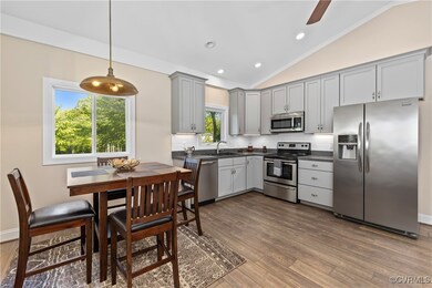 Kitchen with gray cabinets, appliances with stainl