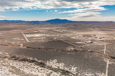 Aerial view of sparsely populated area featuring a desert landscape and a mountainous background