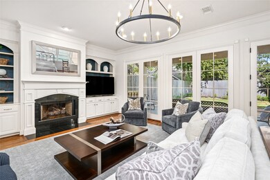 Open family room with wall of windows to the pool