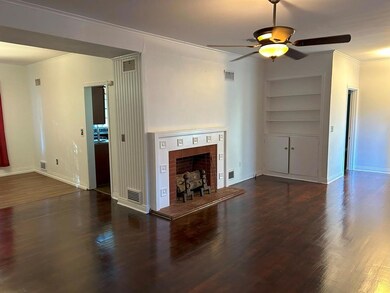 Unfurnished living room featuring dark wood-type f