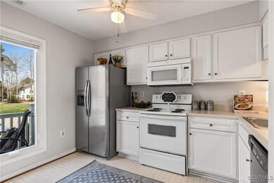 Kitchen with white cabinetry, light floors