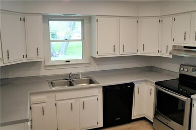 Kitchen with multiple windows, dishwasher, and amp