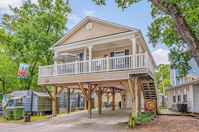Raised beach house with ceiling fan, a carport, an