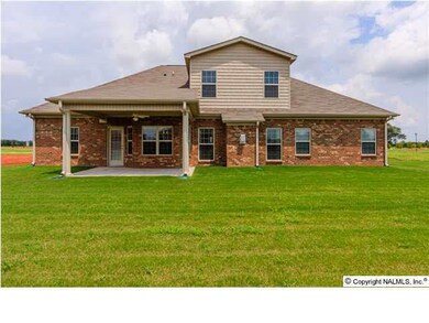 Covered terrace & full sod lawn set the stage for great entertaining.
