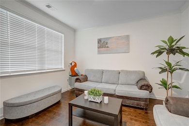 Living room featuring visible vents, baseboards, c