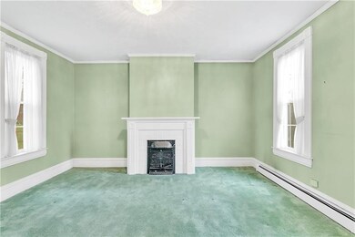 The formal living room offers plenty of natural li