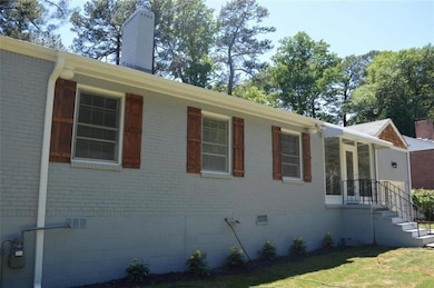 View of home's exterior with a chimney, brick sidi