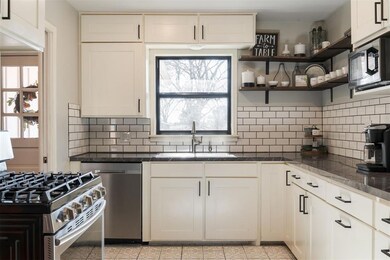 Kitchen with tasteful backsplash, sink, light tile