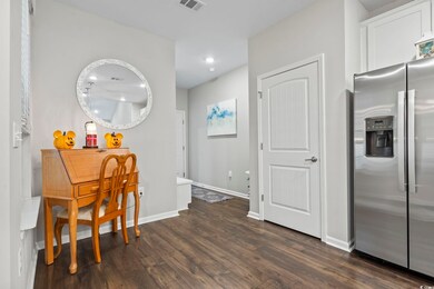 Dining space with dark wood finished floors and recessed lighting