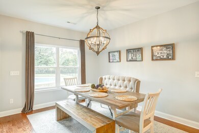 Beautiful light fixtures and hardwood flooring throughout kitchen, dining and living rooms. 