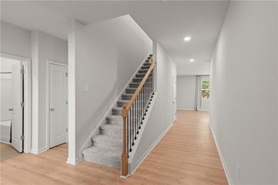 Bright entry hallway with warm flooring and clean lines.