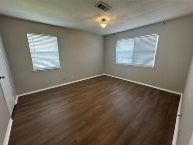 Spare room featuring dark wood finished floors an