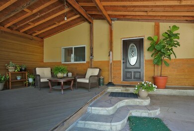 View of exterior entry with a wooden deck