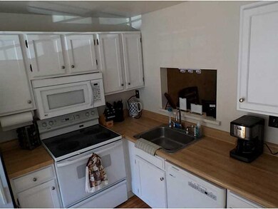 Kitchen. Refaced cabinets with view into living an