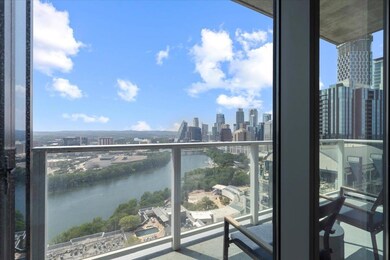Balcony featuring a view of skyline and a water v