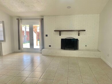 Unfurnished living room featuring tile patterned f