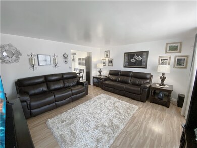 Spacious living room with pergo flooring.