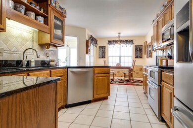 Updated kitchen with dining nook features granite countertops and stainless appliances