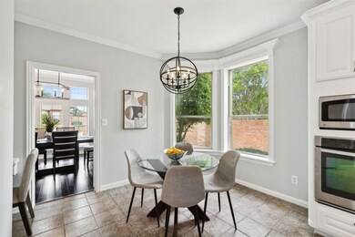 Tiled dining space with crown molding and a chandelier
