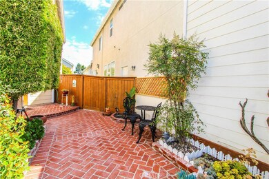 Wider brick accented entry with newer vinyl fencing creates charming setting.