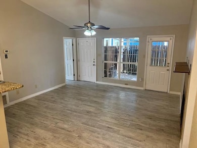 Unfurnished living room featuring wood finished f