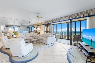 Living area with a ceiling fan and light tile patt
