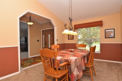 Formal dining room with vaulted ceiling and chair 