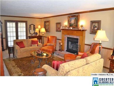 FIREPLACE WITH RAISED HEARTH  AND STAINED WOODEN MANTLE