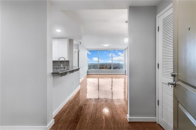 Hallway featuring baseboards and wood finished floors