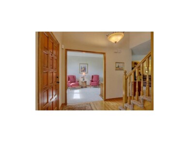 Open and inviting entry area with hardwood floors.