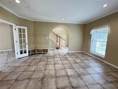 Spare room featuring arched walkways, ornamental 