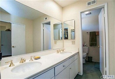 Bathroom has two separate sinks and a tub with enc