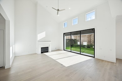 Two story living room is light and bright with gas