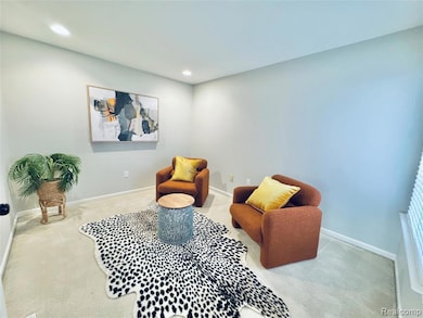 Sitting room with carpet flooring and recessed lighting