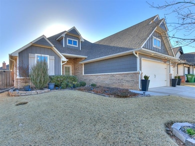 View of front facade with driveway, brick siding, a shingled roof, a garage, and board and batten siding