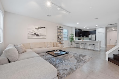 Living area with visible vents, finished concrete