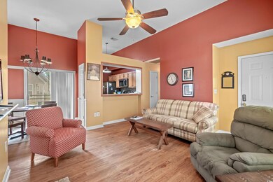 Living room featuring a high ceiling, ceiling fan 