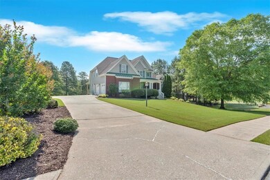 Craftsman-style house featuring a garage, driveway, and a front lawn