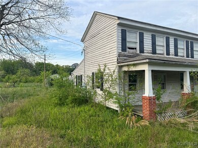 View of side of home featuring a porch
