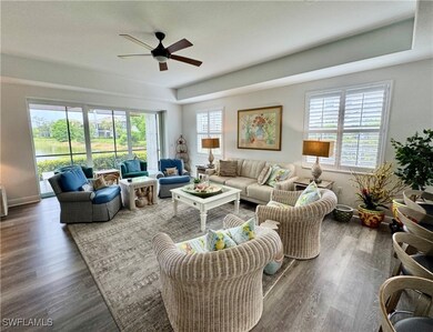 Living room with a ceiling fan, wood finished floo