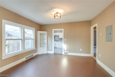Extra-large dining room with built in cabinets.  New dedicated electric panel for Unit 1 (2023).  New windows and light fixtures (2023).