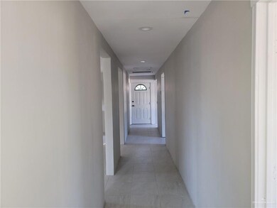Hallway featuring light tile patterned flooring