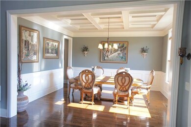 When you enter the home the Formal Dining Room is to the right and has Coffer Ceiling & transom windows which leads to the Butler's Pantry/Wine Bar. 
