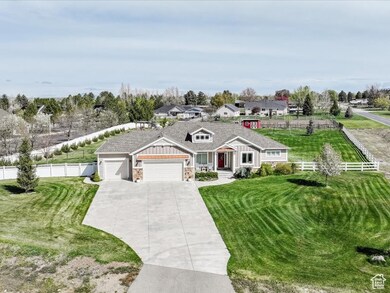 View of front of property featuring a garage, fence, and a front lawn